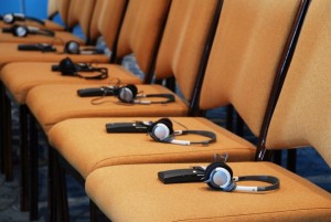 An image of a row of headsets on chairs that represent Language USA's simultaneous interpretation and conference services.