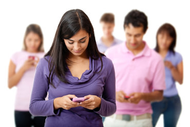 View of several people on their phones representing the need for Language USA's multilingual text services.